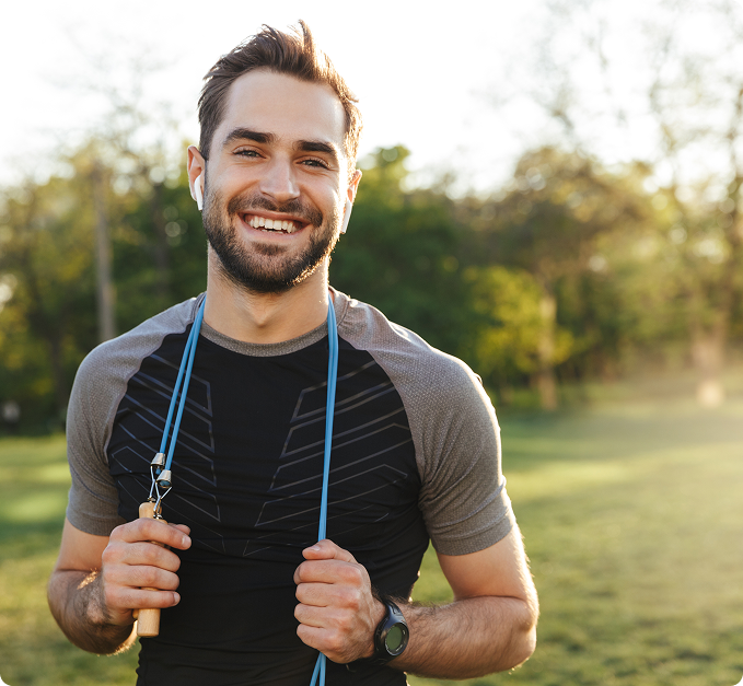 a man holding a jumping rope smiling