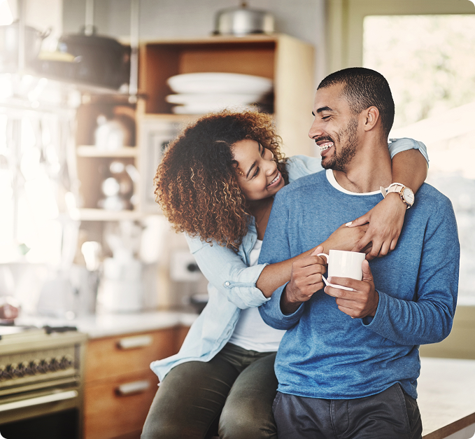 a man and woman smiling towards each other